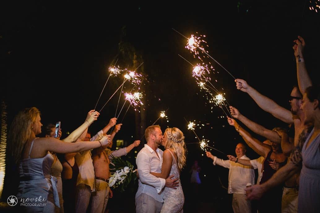 Meg and Christ kissing under sparklers