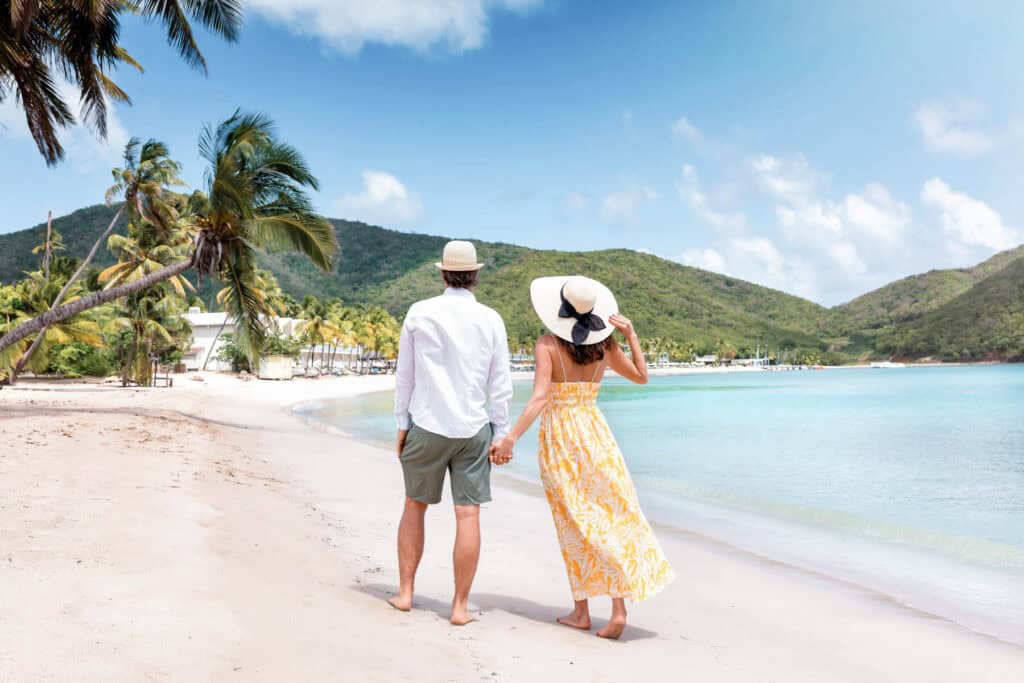 couple walking on the beach on their honeymoon